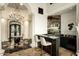 Elegant home bar features sleek black countertops and ample display shelving for bottles and glassware at 7801 N Saguaro Dr, Paradise Valley, AZ 85253