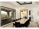 Stylish dining room with large window, modern chandelier, and seating for ten at 7801 N Saguaro Dr, Paradise Valley, AZ 85253