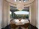 Elegant dining area with large windows offering stunning views, chandelier lighting, and seating for eight at 7801 N Saguaro Dr, Paradise Valley, AZ 85253
