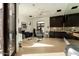 Spacious home gym with modern equipment, dark cabinetry, and a window providing natural light at 7801 N Saguaro Dr, Paradise Valley, AZ 85253