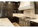 Well-equipped kitchen features custom cabinetry, professional-grade range, and designer backsplash at 7801 N Saguaro Dr, Paradise Valley, AZ 85253