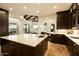 Open kitchen with island, stone countertops, wood cabinets, and a view of the outdoor space at 7801 N Saguaro Dr, Paradise Valley, AZ 85253