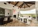 Inviting living area with stone fireplace, custom bar, and expansive windows at 7801 N Saguaro Dr, Paradise Valley, AZ 85253