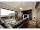 Spacious living room with a cozy fireplace and a large sliding glass door leading to an outdoor area at 7801 N Saguaro Dr, Paradise Valley, AZ 85253