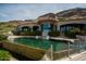 Luxury home featuring a unique pool, spa, and lush landscaping against a mountain backdrop at 7801 N Saguaro Dr, Paradise Valley, AZ 85253