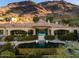 Expansive rear exterior of a luxury home featuring a pool, lush landscaping, and a mountain backdrop at 7801 N Saguaro Dr, Paradise Valley, AZ 85253