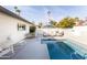 Inviting backyard pool area featuring lounge chairs, an umbrella, and lush landscaping in a private setting at 8132 E Valley View Rd, Scottsdale, AZ 85250