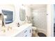 Bright bathroom showcasing a modern vanity, decorative mirrors, and beautifully tiled glass shower at 8132 E Valley View Rd, Scottsdale, AZ 85250