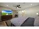 A brightly lit primary bedroom featuring an ensuite and modern decor with a ceiling fan at 8132 E Valley View Rd, Scottsdale, AZ 85250