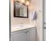 Well-lit bathroom with white cabinetry, modern fixtures, and a framed mirror at 820 W University Dr # 4, Tempe, AZ 85281