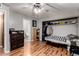 Bedroom with light gray walls, ceiling fan, wood-look floors, and closet at 820 W University Dr # 4, Tempe, AZ 85281