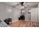 Bedroom with light gray walls, wood-look floors, ceiling fan, and desk at 820 W University Dr # 4, Tempe, AZ 85281