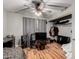 Bedroom with wood-look floors, light gray walls, ceiling fan, and guitars at 820 W University Dr # 4, Tempe, AZ 85281