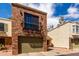 Two-story townhouse featuring a private garage and balcony on the front brick elevation at 820 W University Dr # 4, Tempe, AZ 85281