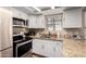 This kitchen features stainless steel appliances, granite countertops, and white cabinetry at 820 W University Dr # 4, Tempe, AZ 85281