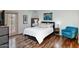 Comfortable bedroom with wood-look floors and updated furniture and light fixtures at 873 W Sterling Pl, Chandler, AZ 85225