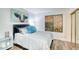 This bedroom features stylish décor, a vibrant painting, and natural light from the stained glass window at 873 W Sterling Pl, Chandler, AZ 85225