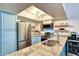 Modern kitchen featuring stainless steel appliances, granite countertops, and ample cabinet space at 873 W Sterling Pl, Chandler, AZ 85225