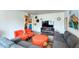Well-appointed living room featuring a large gray sofa, orange accents, and stylish decor at 873 W Sterling Pl, Chandler, AZ 85225