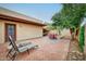 Relaxing brick patio with lounge chairs, dining set, and manicured landscaping offers a private outdoor retreat at 873 W Sterling Pl, Chandler, AZ 85225
