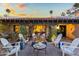 Backyard patio view features white seating around a fire pit and lush, flowering vines at 8814 N 86Th St, Scottsdale, AZ 85258