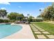 Beautiful backyard featuring a pristine pool, lush landscaping, and shaded outdoor seating area at 8814 N 86Th St, Scottsdale, AZ 85258