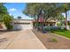 Charming home featuring a lush front yard, mature trees, and a driveway leading to the attached garage at 8814 N 86Th St, Scottsdale, AZ 85258