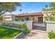 Inviting home showcasing a beautifully landscaped front yard with a gated entrance and a charming tile roof at 8814 N 86Th St, Scottsdale, AZ 85258