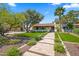 Charming home featuring a tile roof, lush landscaping, and a stone tile walkway leading to the inviting front entrance at 8814 N 86Th St, Scottsdale, AZ 85258
