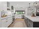 Contemporary kitchen with white cabinetry, a farmhouse sink, and stainless steel appliances at 8814 N 86Th St, Scottsdale, AZ 85258