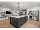 Open-concept kitchen with island seating, stainless steel appliances, and seamless flow to the living space at 8814 N 86Th St, Scottsdale, AZ 85258