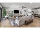 Comfortable living area with modern decor, light gray sofa, accent chairs, and abundant natural light at 8814 N 86Th St, Scottsdale, AZ 85258