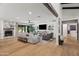 Bright living room with a large sectional couch, fireplace, and wood beam accents at 8814 N 86Th St, Scottsdale, AZ 85258