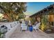A relaxing outdoor seating area features a fire pit, white chairs, and a cushioned bench at 8814 N 86Th St, Scottsdale, AZ 85258
