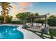 An outdoor living space, with a fire pit, wicker seating, and string lights at 8814 N 86Th St, Scottsdale, AZ 85258