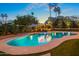 Serene backyard pool with ambient lighting, cozy pergola, mature trees, and a relaxing seating area at 8814 N 86Th St, Scottsdale, AZ 85258