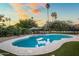 Pool with well-manicured landscaping, and a lounging area, surrounded by artificial turf at 8814 N 86Th St, Scottsdale, AZ 85258