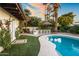 An inviting outdoor space showcasing pool with bar, lush lawn, and decorative tile accents at 8814 N 86Th St, Scottsdale, AZ 85258