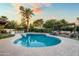 Inviting backyard pool with lush landscaping, outdoor kitchen, and pergola covered seating area at 8814 N 86Th St, Scottsdale, AZ 85258