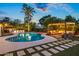 Inviting backyard pool area featuring a cozy pergola with seating and lush landscaping, great for entertaining at 8814 N 86Th St, Scottsdale, AZ 85258