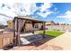 Inviting backyard featuring a gazebo, built-in BBQ, and a lush artificial lawn area for outdoor enjoyment at 900 E Saratoga St, Gilbert, AZ 85296