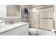 A well-lit bathroom with tiled shower and vanity at 900 E Saratoga St, Gilbert, AZ 85296