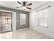 Cozy bedroom featuring a sliding glass door, tile floors, neutral paint and modern ceiling fan at 900 E Saratoga St, Gilbert, AZ 85296
