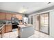 Well-lit kitchen featuring an island, stainless steel appliances, and sliding glass door to the patio at 900 E Saratoga St, Gilbert, AZ 85296