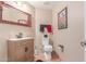 A bathroom with a sink, toilet, decorative mirror, and unique tiled floors at 9137 E Odessa St, Mesa, AZ 85207