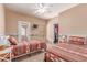 Bright bedroom featuring two twin beds, a ceiling fan, and a closet at 9137 E Odessa St, Mesa, AZ 85207