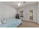 Bright bedroom with a queen bed, featuring a ceiling fan and direct access to the outside at 9137 E Odessa St, Mesa, AZ 85207