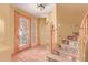Welcoming foyer with tiled floors, a decorative front door, and staircase at 9137 E Odessa St, Mesa, AZ 85207