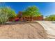 Charming two-story home with desert landscaping, beautiful trees and concrete driveway at 9137 E Odessa St, Mesa, AZ 85207