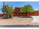 Inviting two-story home with desert landscaping and mature trees, near a concrete driveway at 9137 E Odessa St, Mesa, AZ 85207
